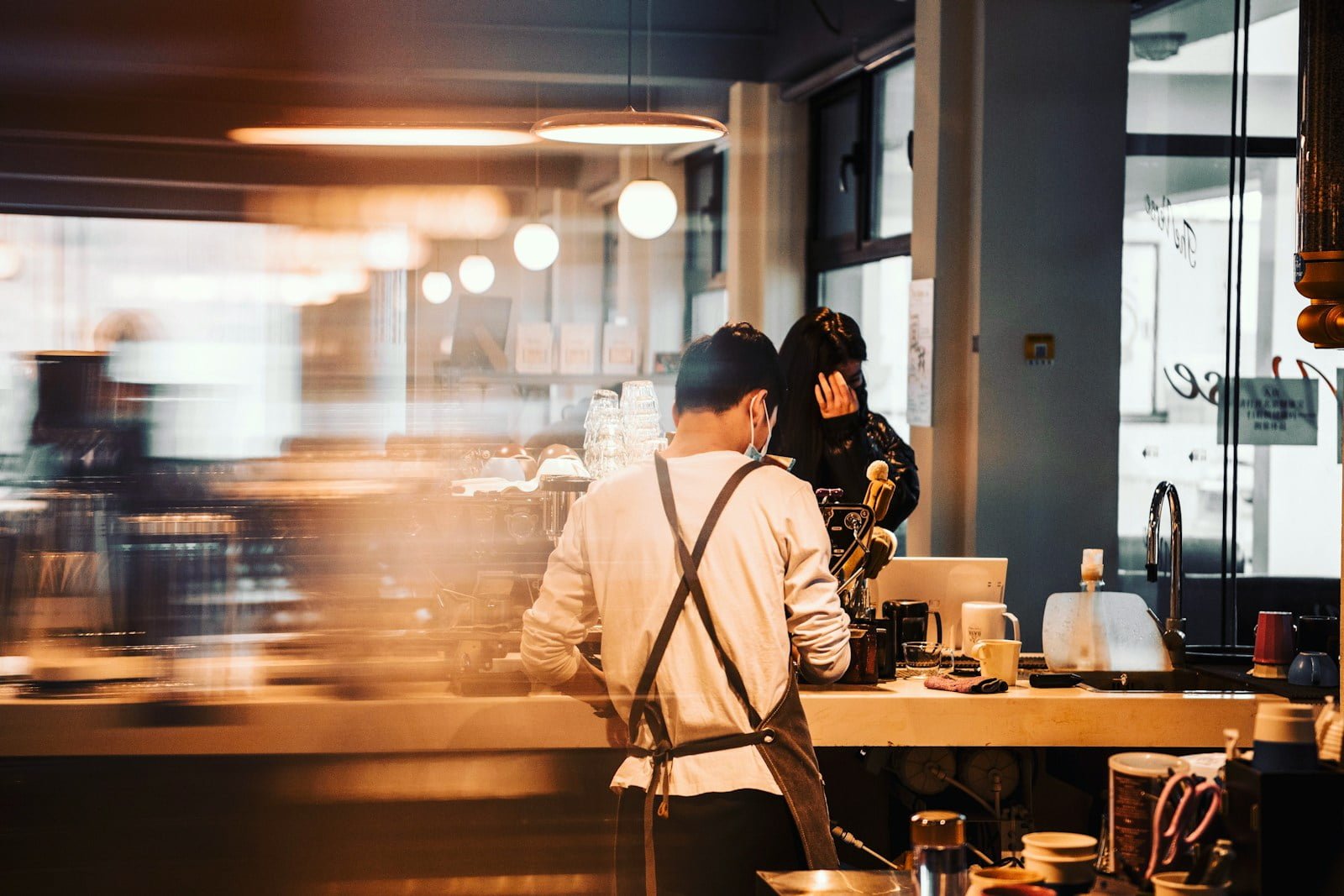 propietario de un restaurante - man and woman sitting on chair in front of table