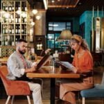 Diseño de Menús para Restaurantes - Man and Woman Sitting on Chair in Restaurant