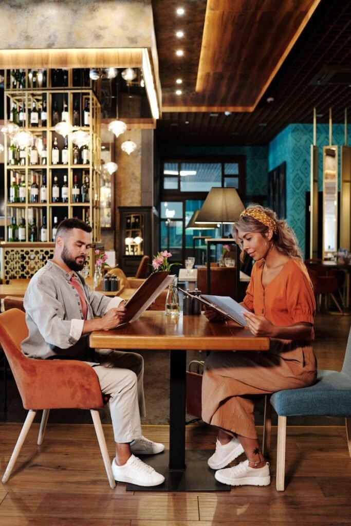 Diseño de Menús para Restaurantes - Man and Woman Sitting on Chair in Restaurant
